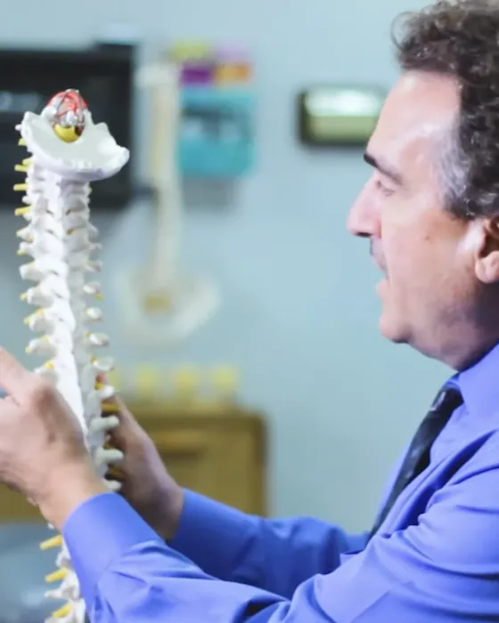 Dr. Anthony Wolf explaining the spine with a model